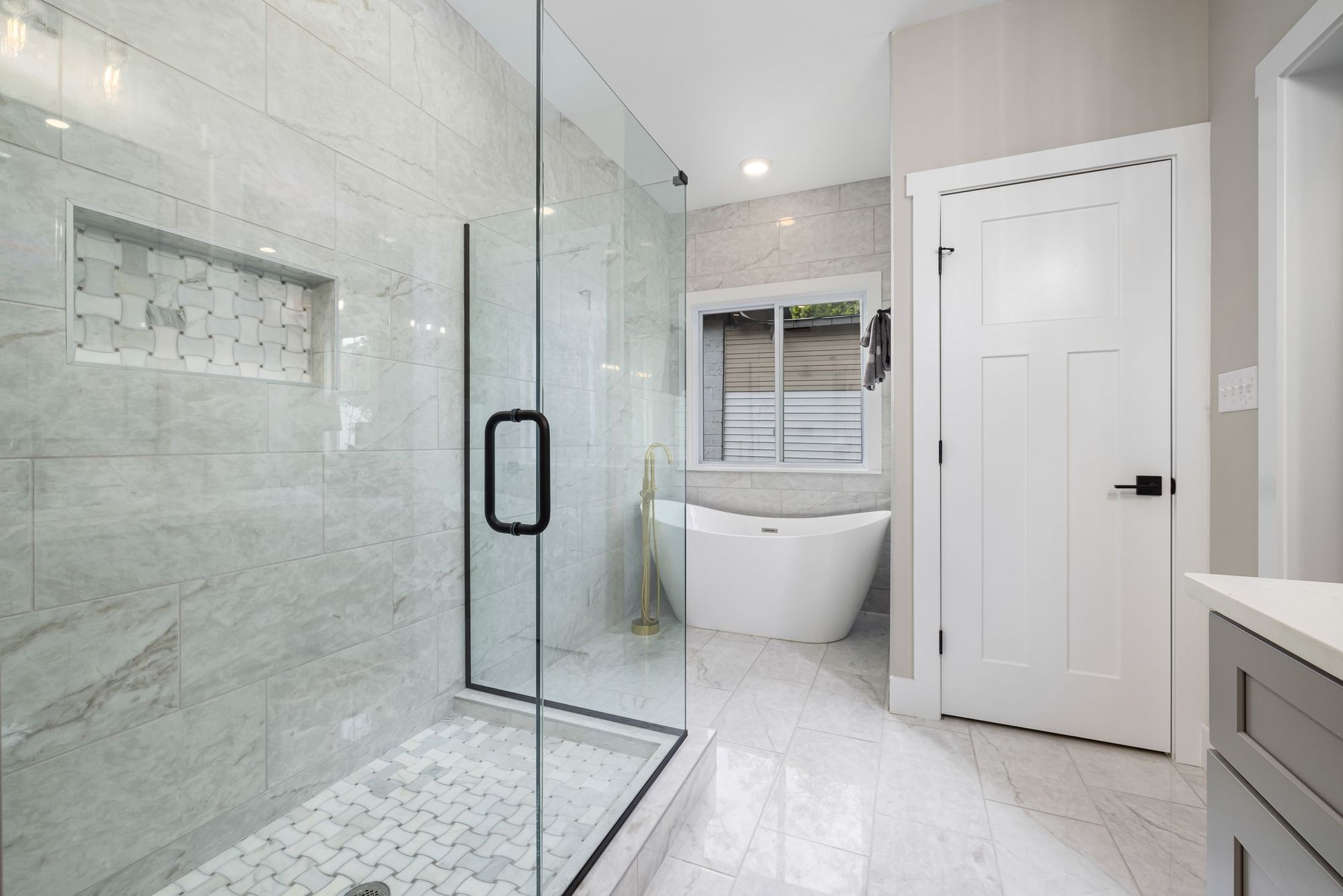 Curbless walk-in shower with a linear drain and built-in bench